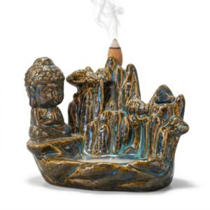 Quemador de incienso cascada de humo de cerámica esmaltada marrón y azul con figura de Buda sentado meditando junto a un paisaje de montaña, con humo descendiendo.